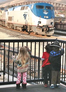 photo of youngsters waving to train